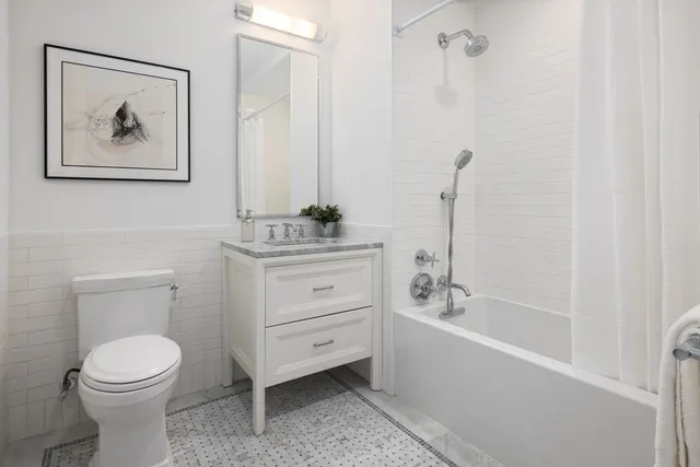 a bathroom with a toilet a sink and bathtub