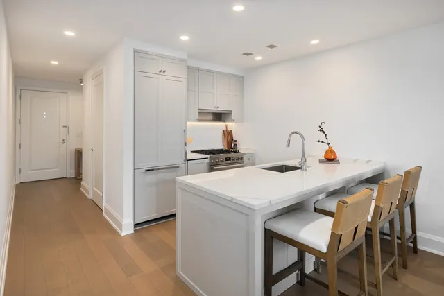 a kitchen that has a table and chairs in it