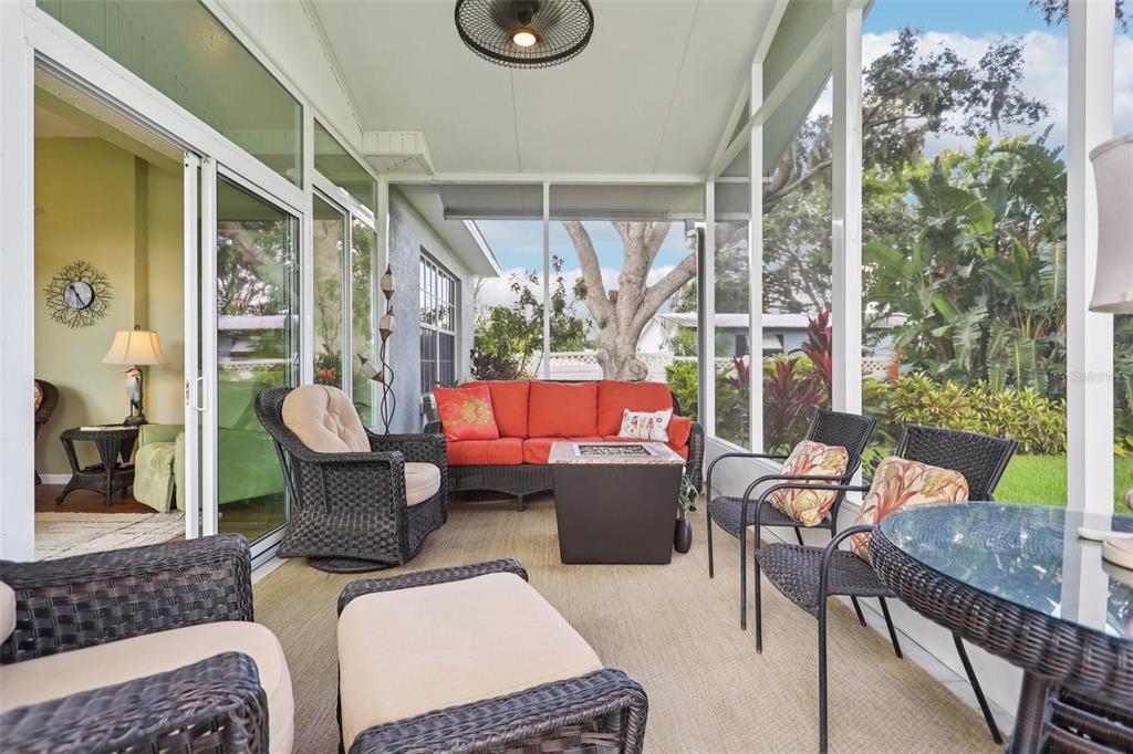 2512 Baywater Road Tavares, FL 32778 - Photo 14 of 75 a living room with furniture a fireplace and a floor to ceiling window