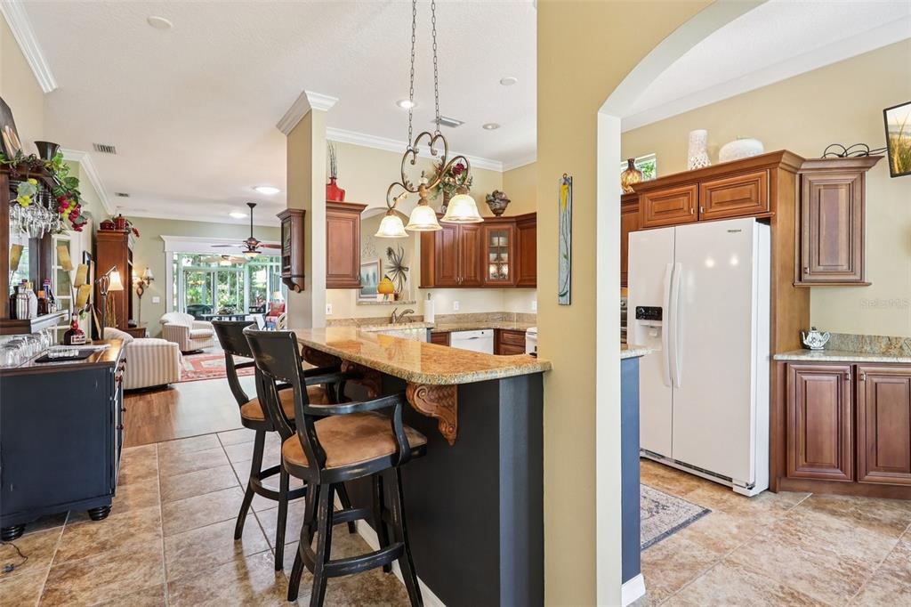 2512 Baywater Road Tavares, FL 32778 - Photo 15 of 75 a kitchen with stainless steel appliances kitchen island granite countertop dining table chairs and granite counter tops