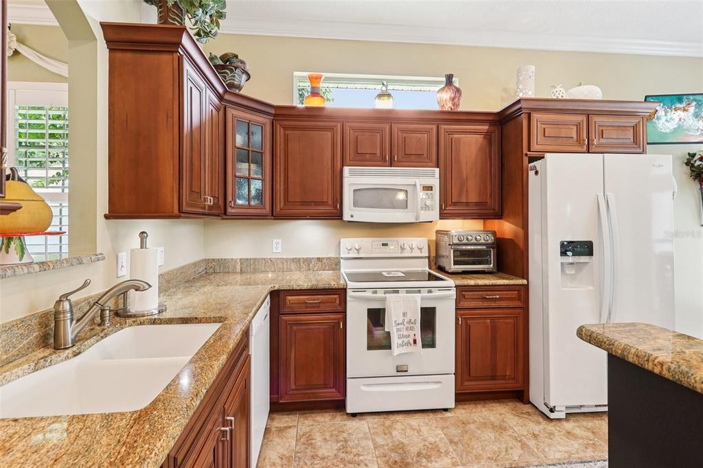 2512 Baywater Road Tavares, FL 32778 - Photo 18 of 75 a kitchen with stainless steel appliances granite countertop a refrigerator sink and stove