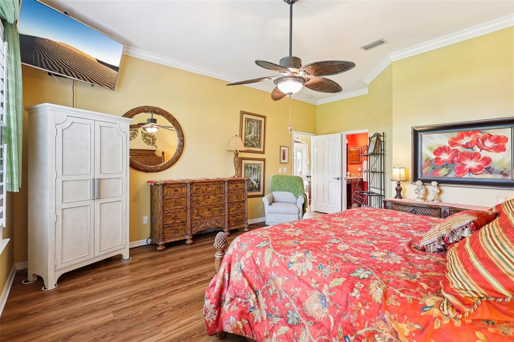 2512 Baywater Road Tavares, FL 32778 - Photo 27 of 75 a bedroom with a bed a dresser and flat screen tv