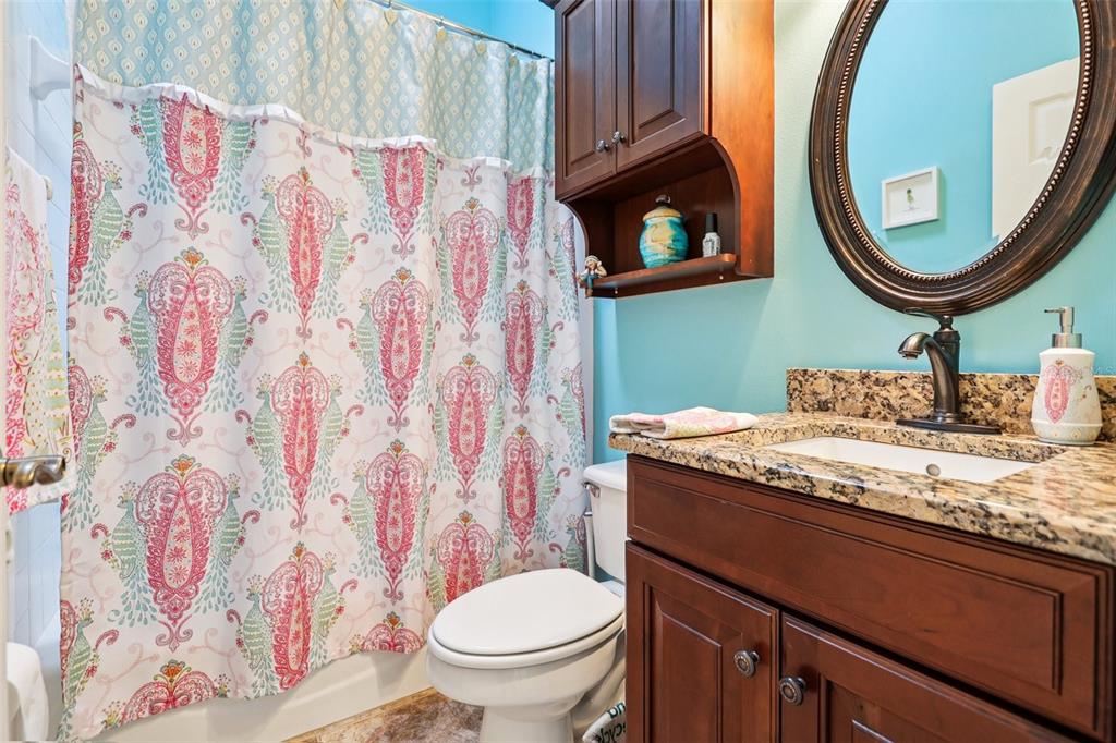 2512 Baywater Road Tavares, FL 32778 - Photo 32 of 75 a bathroom with a granite countertop sink and a mirror