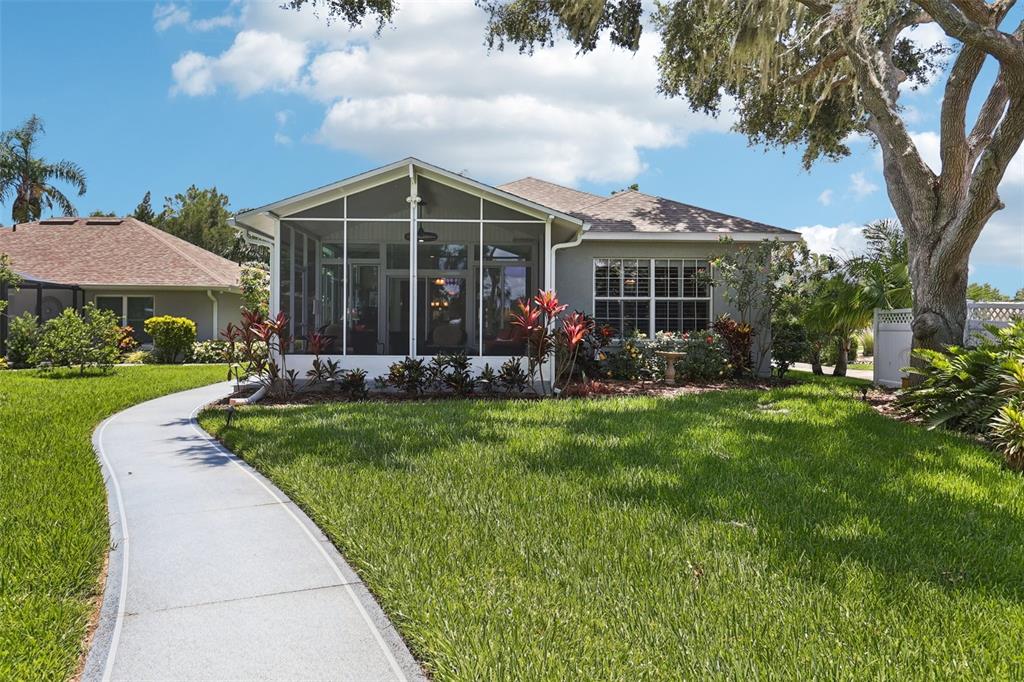 2512 Baywater Road Tavares, FL 32778 - Photo 36 of 75 a view of a house with a yard and potted plants