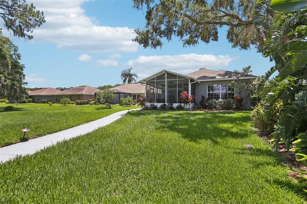 2512 Baywater Road Tavares, FL 32778 - Photo 37 of 75 a view of a house with a big yard and large trees