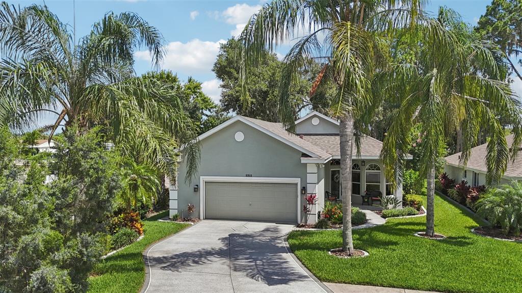 2512 Baywater Road Tavares, FL 32778 - Photo 65 of 75 a front view of a house with a yard and potted plants