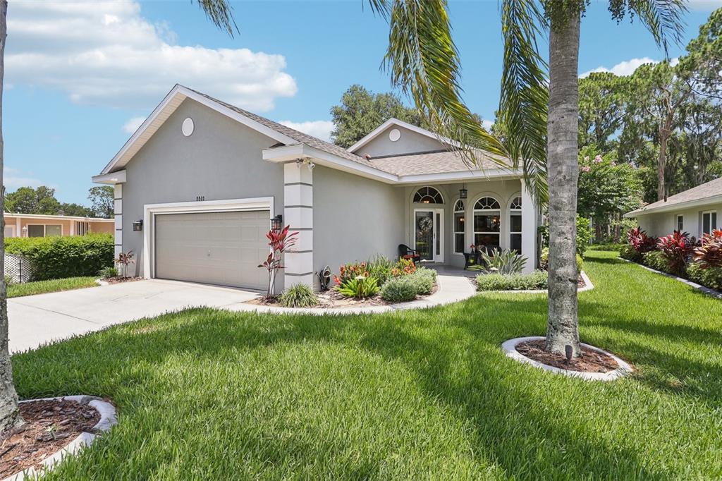 2512 Baywater Road Tavares, FL 32778 - Photo 74 of 75 a front view of a house with a yard and garage