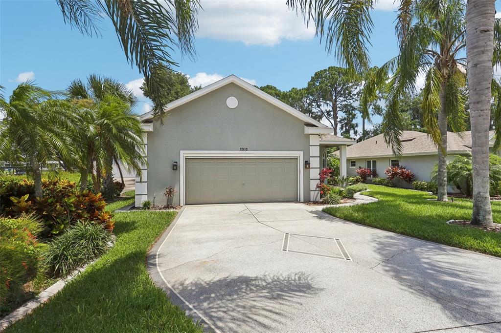 2512 Baywater Road Tavares, FL 32778 - Photo 75 of 75 a front view of a house with a yard and a garage