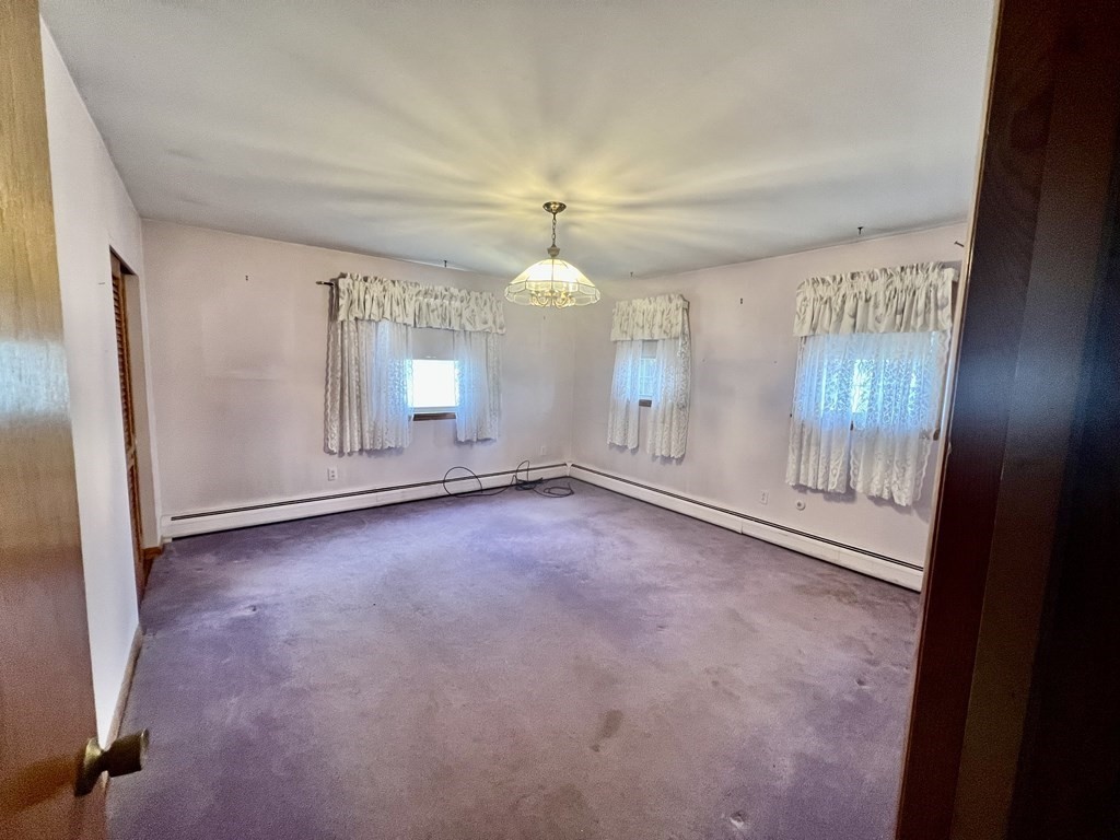 44 Burlingame Road Charlton, MA 01507 - Photo 11 of 29 an empty room with chandelier fan and windows