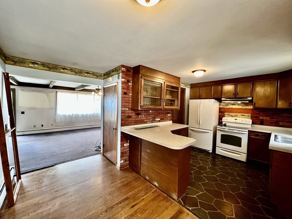 44 Burlingame Road Charlton, MA 01507 - Photo 2 of 29 a kitchen with stainless steel appliances kitchen island granite countertop a stove refrigerator and cabinets