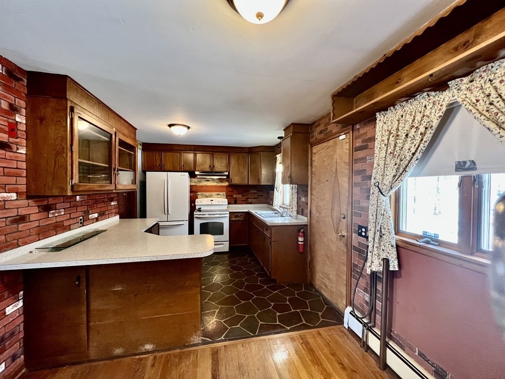 44 Burlingame Road Charlton, MA 01507 - Photo 4 of 29 a kitchen with stainless steel appliances granite countertop a sink refrigerator and cabinets
