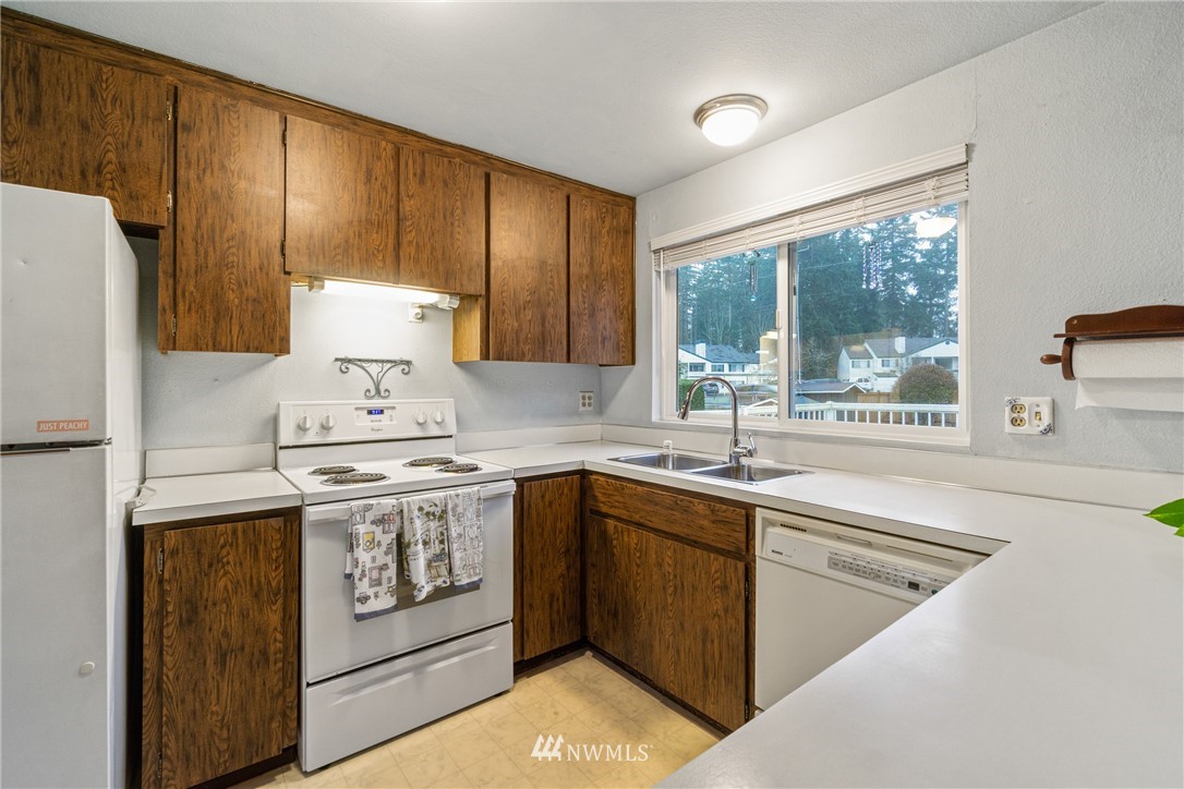 22508 3rd Place West Bothell, WA 98021 - Photo 14 of 23 a kitchen with a sink stove and refrigerator