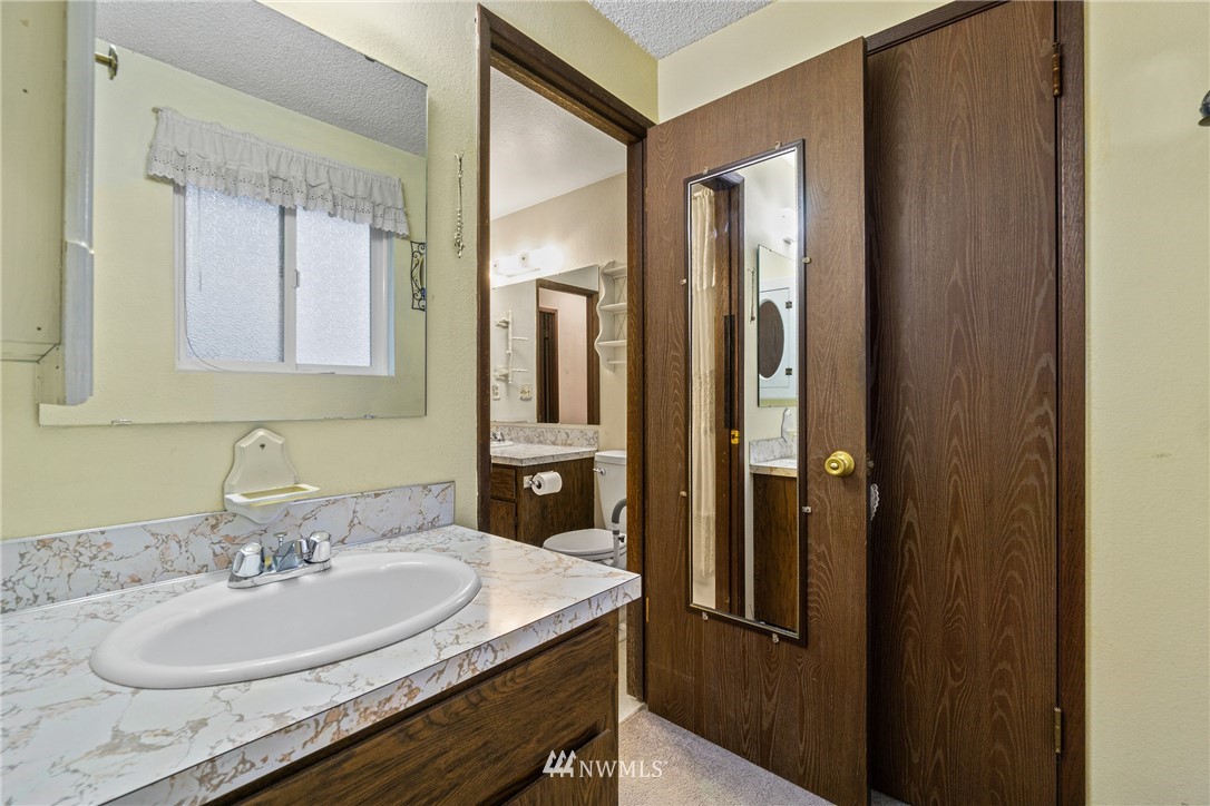 22508 3rd Place West Bothell, WA 98021 - Photo 20 of 23 a bathroom with a granite countertop sink and a mirror