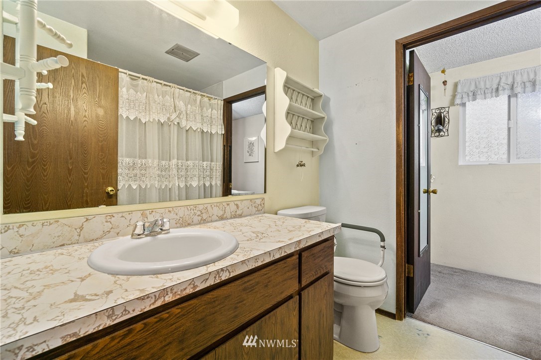 22508 3rd Place West Bothell, WA 98021 - Photo 22 of 23 a bathroom with a granite countertop sink toilet and shower