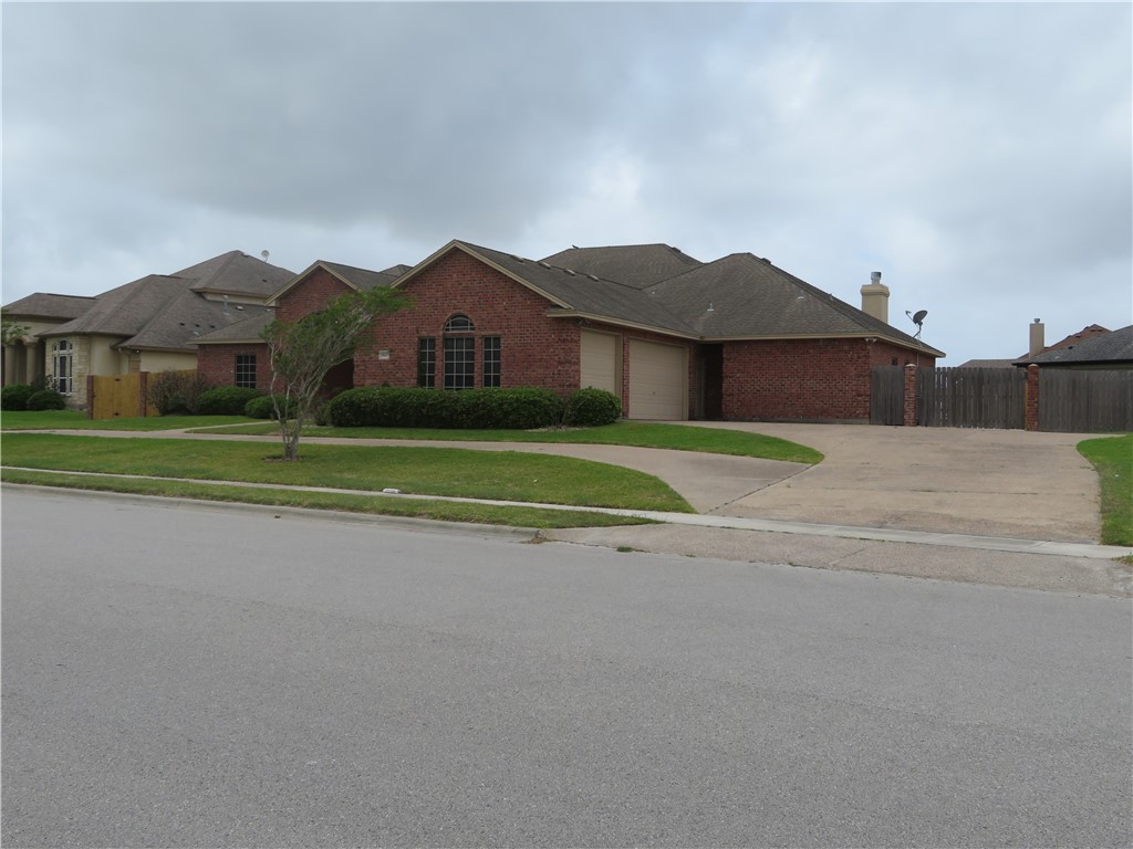 5803 South Oso Parkway Corpus Christi, TX 78414 - Photo 2 of 39 a big house with a big yard and plants