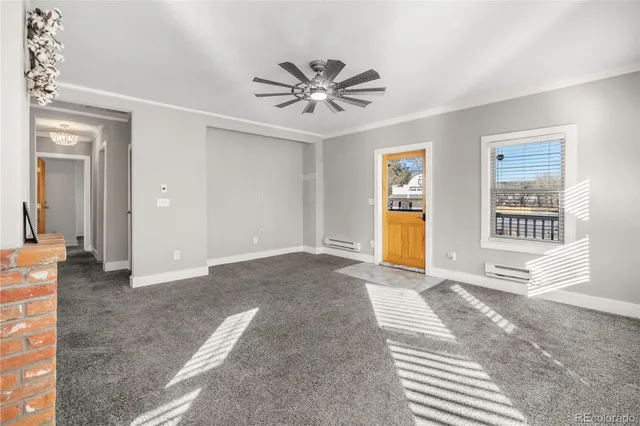 a view of a livingroom with a window and a ceiling fan
