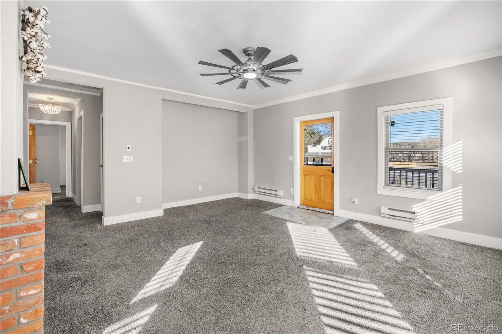 375 Main Street Elizabeth, CO 80107 - Photo 11 of 43 a view of a livingroom with a window and a ceiling fan