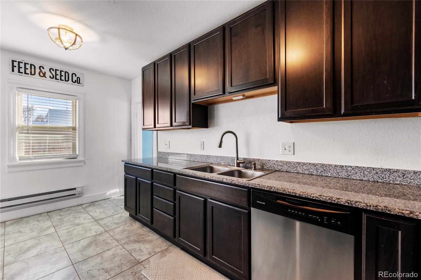 375 Main Street Elizabeth, CO 80107 - Photo 16 of 43 a kitchen with stainless steel appliances granite countertop a sink stove and cabinets