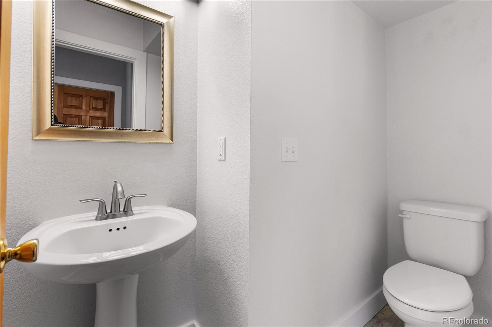 375 Main Street Elizabeth, CO 80107 - Photo 17 of 43 a bathroom with a toilet sink and mirror