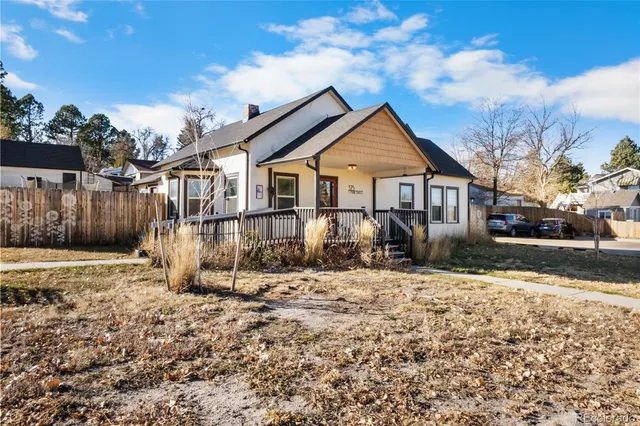 a view of a house with a yard covered in snow