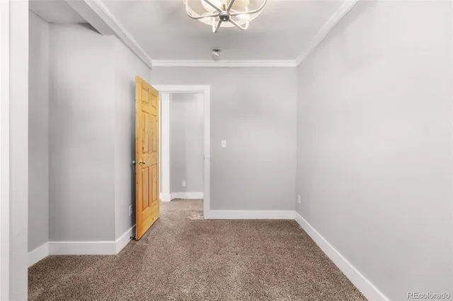 an empty room with a ceiling fan and a window