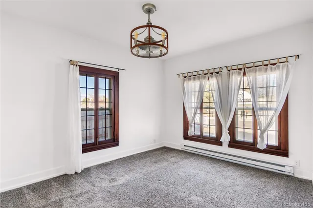 an empty room with windows and closet