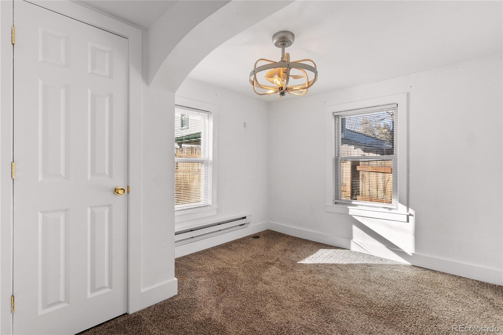 375 Main Street Elizabeth, CO 80107 - Photo 29 of 43 an empty room with windows and ceiling fan