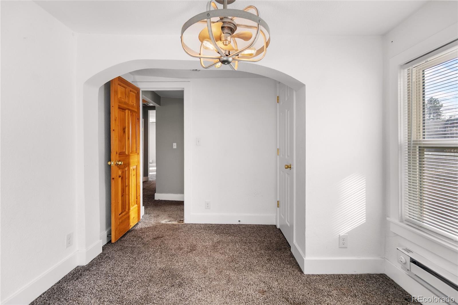 375 Main Street Elizabeth, CO 80107 - Photo 30 of 43 an empty room with a dining table and chandelier