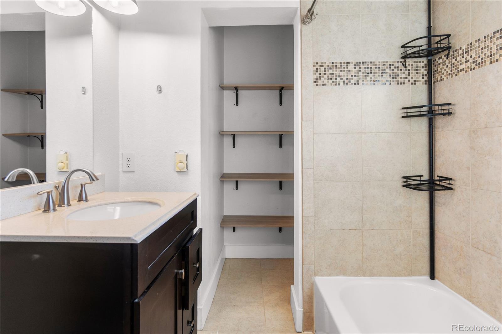 375 Main Street Elizabeth, CO 80107 - Photo 32 of 43 a bathroom with a sink a toilet and shower