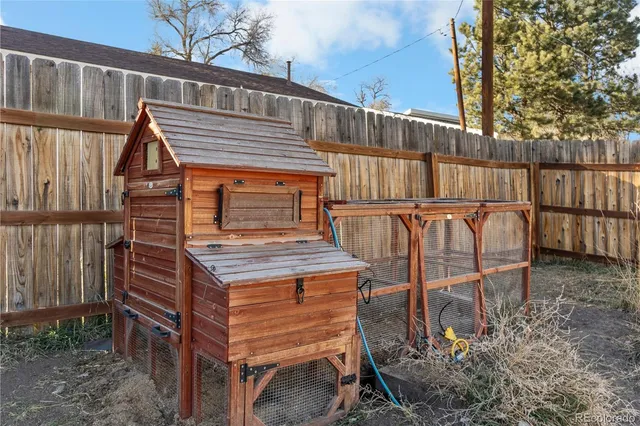 an aerial view of a house with large trees