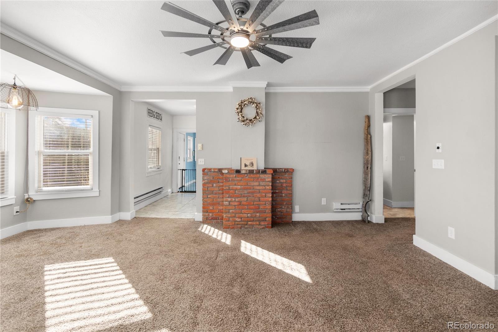 375 Main Street Elizabeth, CO 80107 - Photo 7 of 43 a view of a livingroom with a furniture a ceiling fan and wooden floor