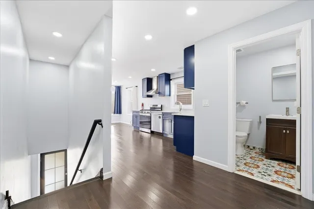 a view of kitchen with sink and refrigerator
