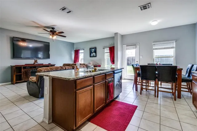 a kitchen with stainless steel appliances granite countertop a stove sink and cabinets