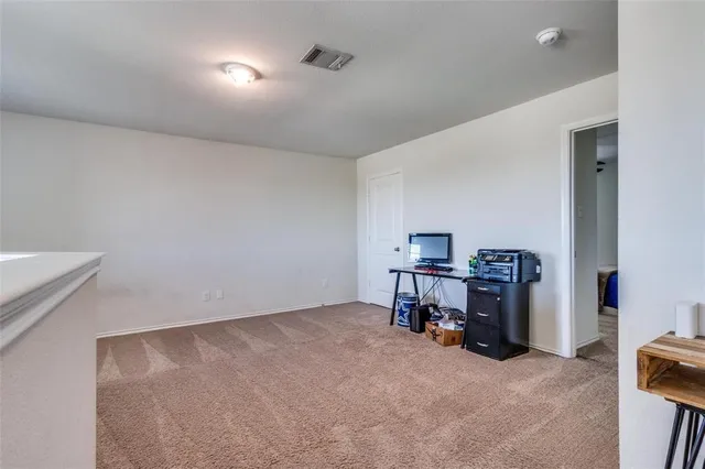 a view of a livingroom with furniture and a kitchen