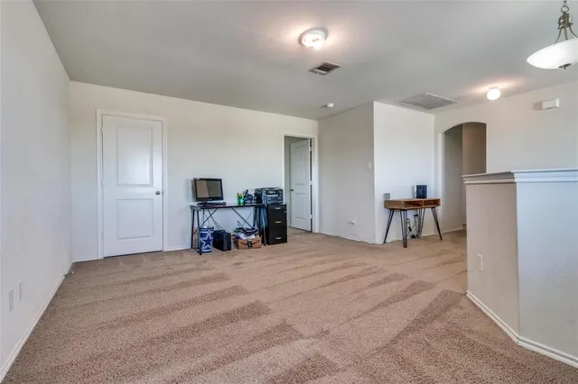 a bedroom with a bed and a ceiling fan