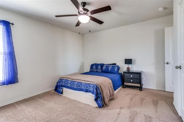 a bathroom with a granite countertop sink a toilet and a mirror