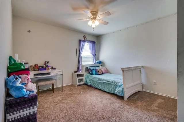 a view of a yard with wooden fence