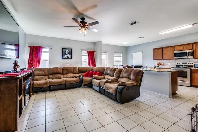 a kitchen with stainless steel appliances granite countertop a sink stove refrigerator and cabinets