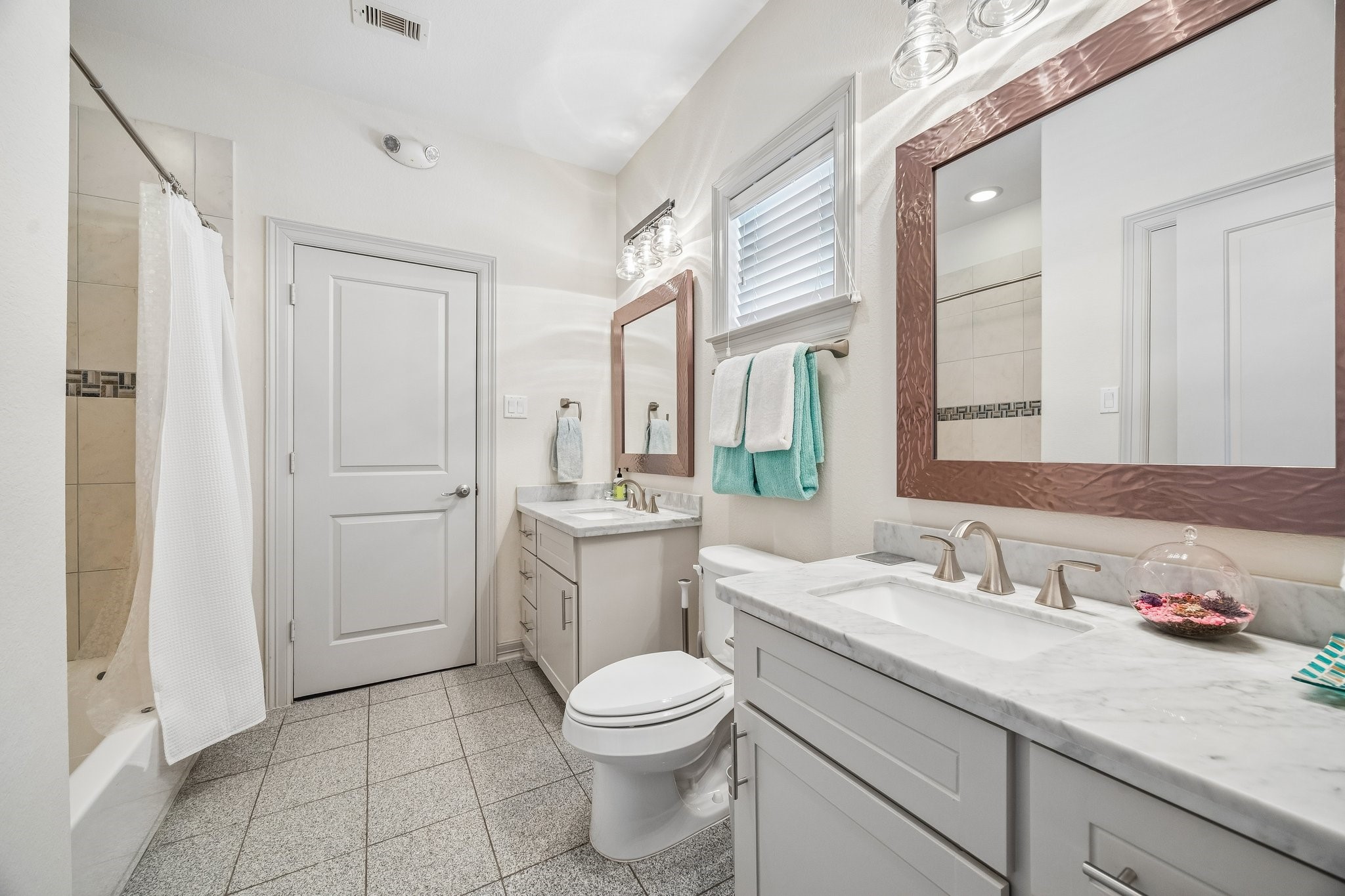 638 Heights Boulevard Houston, TX 77007 - Photo 27 of 49 a bathroom with a granite countertop sink a toilet and a mirror