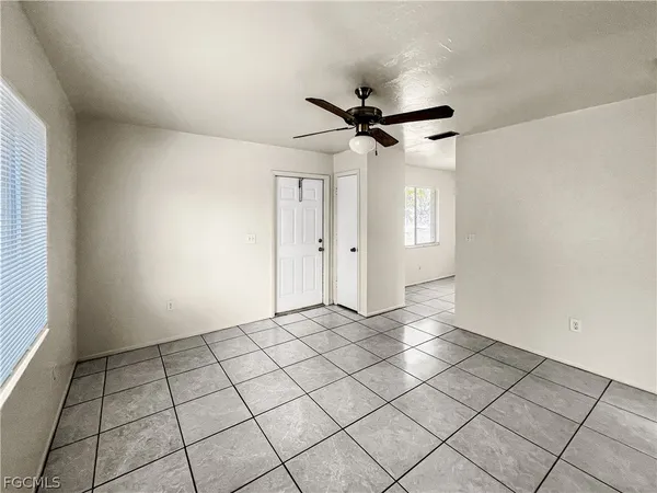 a view of a livingroom with a ceiling fan and window