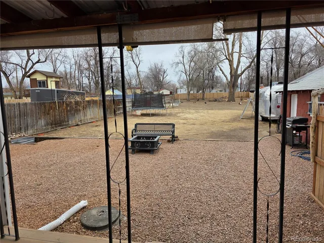 a view of backyard with a table and chairs