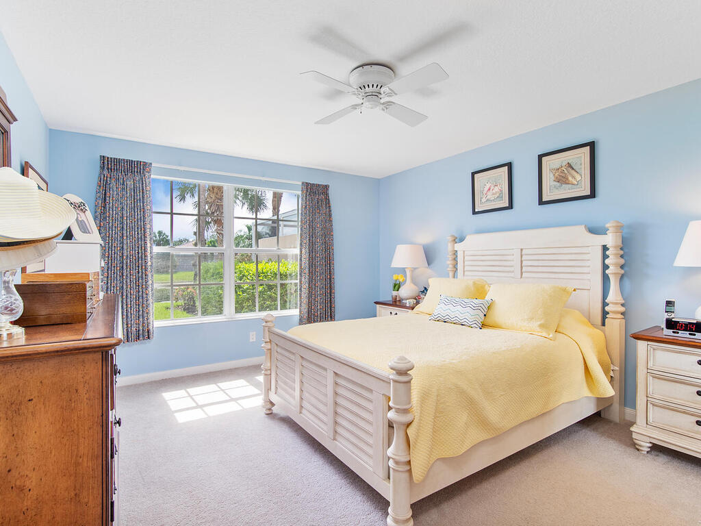 3074 Futuna Lane Naples, FL 34119 - Photo 16 of 28 a bedroom with a bed and a night stand