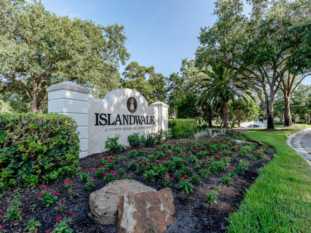 3074 Futuna Lane Naples, FL 34119 - Photo 21 of 28 a sign that is sitting in the garden