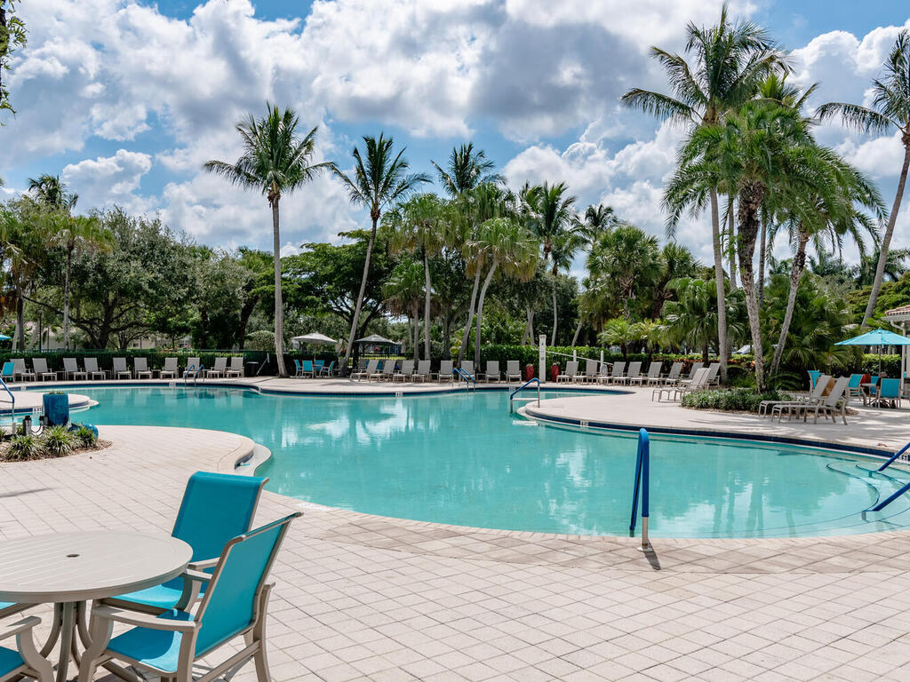 3074 Futuna Lane Naples, FL 34119 - Photo 24 of 28 a view of a swimming pool with a patio and a lake view