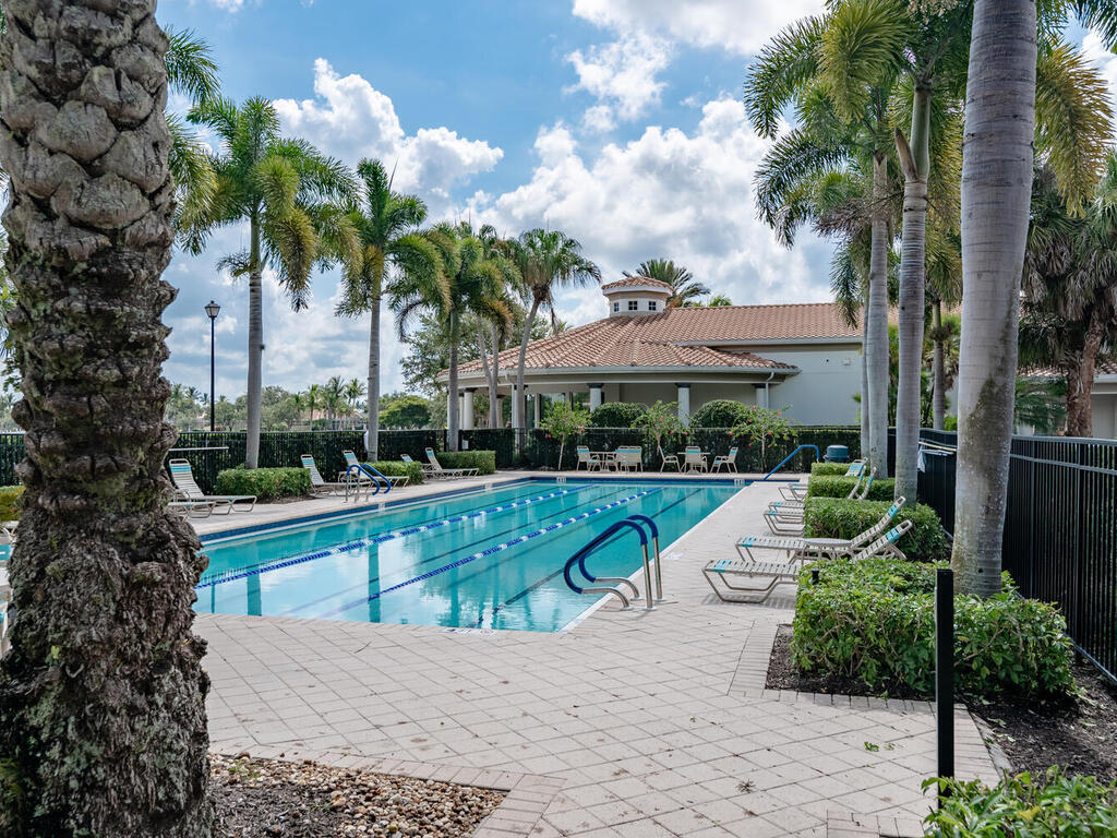 3074 Futuna Lane Naples, FL 34119 - Photo 25 of 28 a view of a house with swimming pool and next to a yard