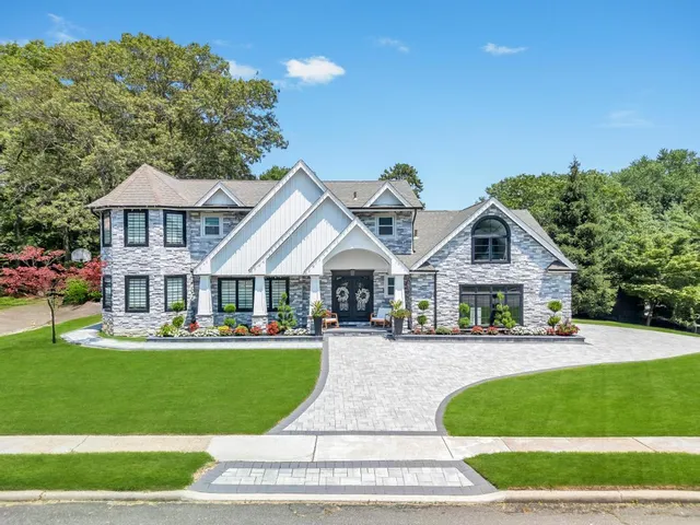 a front view of a house with a yard table and chairs