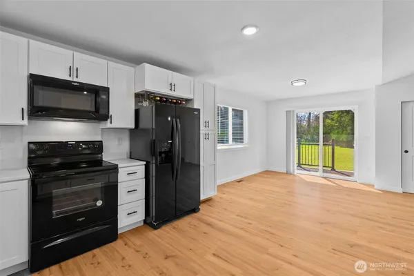 a view of a kitchen with a stove cabinets and a window