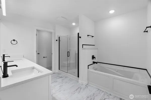 a bathroom with a sink a tub and a mirror
