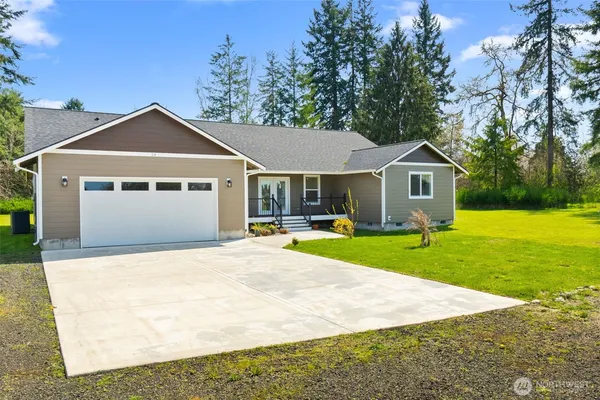a front view of a house with yard and green space