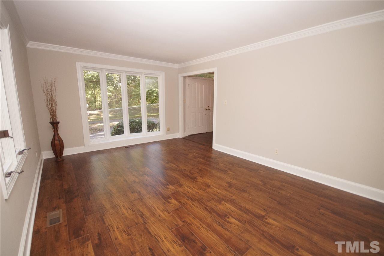 11605 Old Creedmoor Road Raleigh, NC 27613 - Photo 3 of 25 an empty room with wooden floor and windows